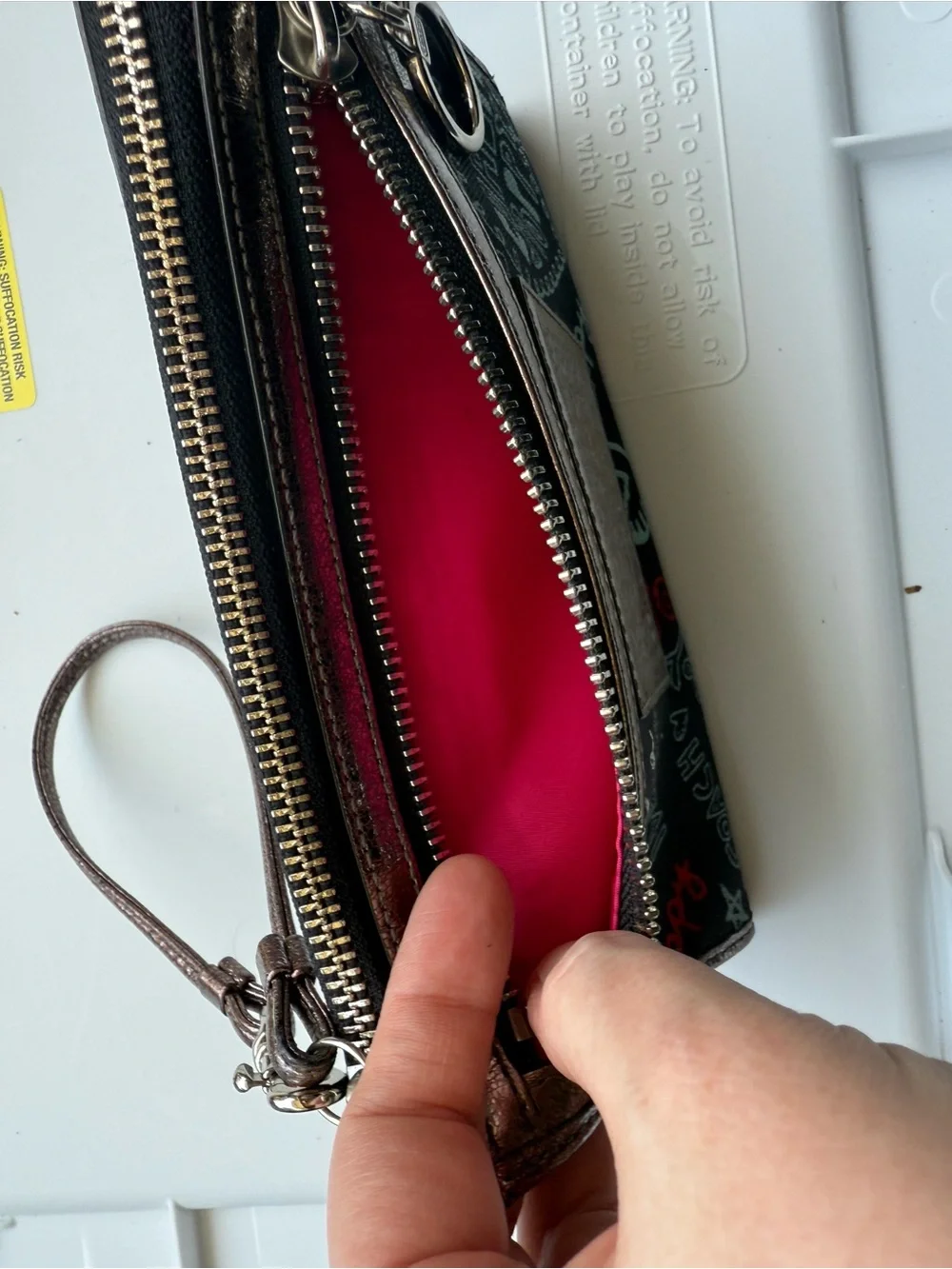 Coach Black Poppy Graffiti Print Wristlet with Bronze Trim and Red Accents